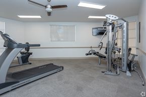 Tucson apartment for rent - A home gym with a treadmill, a stationary bike, and a multi-gym machine.