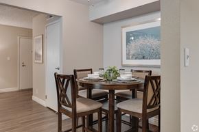 Mesa apartment for rent - A dining room with a table set for two and a painting on the wall.
