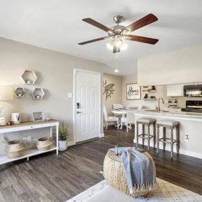 Katy apartment for rent - A kitchen with a white door and a white table with chairs.