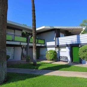 Scottsdale apartment for rent - A building with a green door and a bench in front of it.