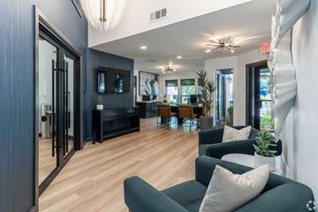 Plano apartment for rent - A living room with a grey couch and a wooden floor.