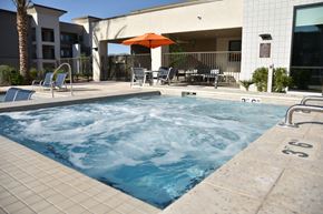 Tucson apartment for rent - A pool with a hot tub in the middle of it.