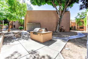 Phoenix apartment for rent - A tree is in front of a tan building.