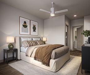 Tucson apartment for rent - A bedroom with a large bed and a ceiling fan.