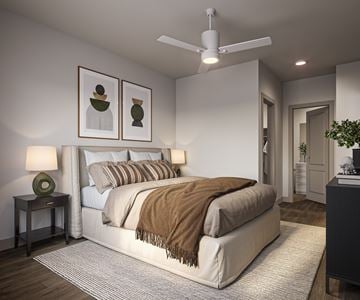 Tucson apartment for rent - A bedroom with a large bed and a ceiling fan.