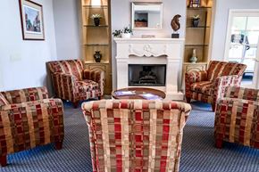 Sun City apartment for rent - A living room with a fireplace and chairs.