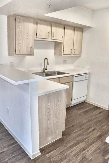Sun City apartment for rent - A kitchen with wooden cabinets and a white counter.