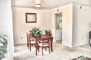 Sun City apartment for rent - A dining room with a wooden table and chairs.