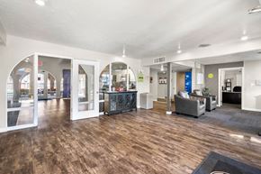 Tucson apartment for rent - A spacious office lobby with a wooden floor and white walls.