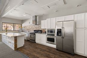Tucson apartment for rent - A modern kitchen with stainless steel appliances and white cabinetry.