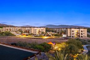 Tuscon apartment for rent - A resort with a pool and a mountain in the background.