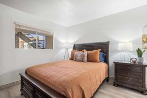 Sierra Vista apartment for rent - A bedroom with a bed, nightstand, and a window.