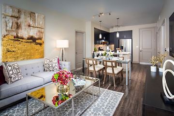 Scottsdale apartment for rent - A modern living room with a glass coffee table and a grey sofa.