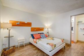 Tucson apartment for rent - A bedroom with a bed, nightstands, and a lamp.