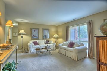 Harrisburg apartment for rent - A living room with a white couch and a white chair.