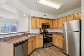 Harrisburg apartment for rent - A kitchen with wooden cabinets and stainless steel appliances.