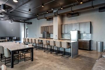 Philadelphia apartment for rent - A modern kitchen with a long table and chairs.
