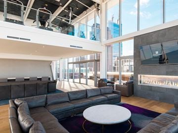 Philadelphia apartment for rent - A modern living room with a large grey sofa and a white coffee table.