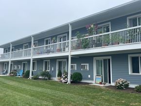 Narragansett apartment for rent - a blue building with a balcony and a grass field