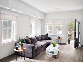 Brewster apartment for rent - a living room with white walls and a gray couch