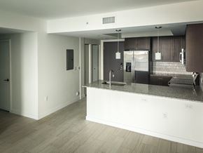 Miami apartment for rent - an open kitchen and living room with a granite counter top at Meridian Point at Goulds Station in Miami, FL, 33170