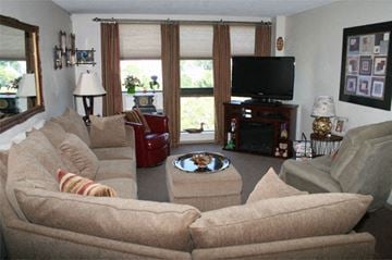 Dover apartment for rent - A living room with a large couch and a television.