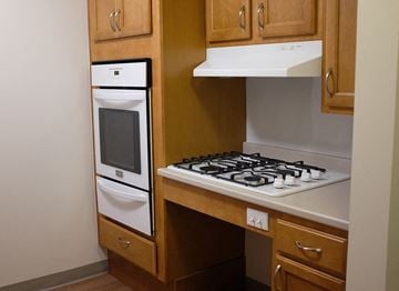 Bedford apartment for rent - a kitchen with a stove top oven and a sink