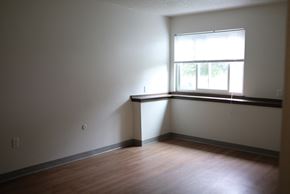Bedford apartment for rent - an empty room with a window and wooden floors