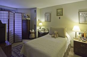 Boston apartment for rent - a bedroom with a bed and a teddy bear