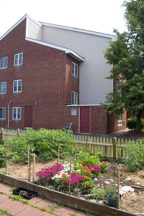 Randolph apartment for rent - a garden in front of a brick building