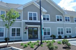 Bourne apartment for rent - the front of a white building with a sign on it