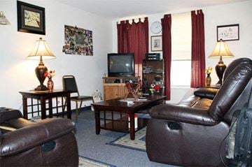 Pittsfield apartment for rent - a living room with leather furniture and a television