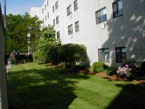 Lynn apartment for rent - a large white building with a yard in front of it