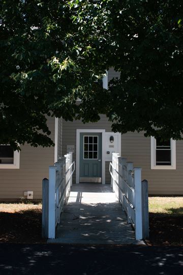 Hyannis apartment for rent - a white house with a white walkway and a green door