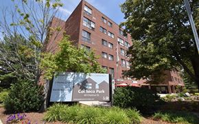 Dover apartment for rent - A sign for Cocheco Park in front of a brick building.