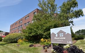 Dover apartment for rent - A building with a sign that says Riverview in front of it.