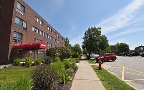 Dover apartment for rent - A red fire hydrant is on the grass next to a sidewalk.