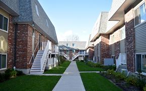 Cambridge townhouse for rent - A long white pathway leads between two rows of houses.