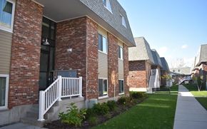 Cambridge townhouse for rent - A row of houses with a white picket fence in front.