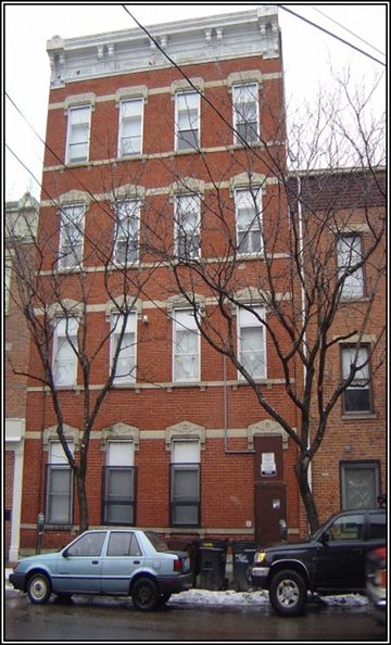 Cincinnati apartment for rent - a red brick building with cars parked in front of it