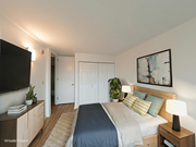 Chicago apartment for rent - A bedroom with a bed, nightstand, and a television.