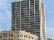 Chicago apartment for rent - A tall building with a green arrow on the side.