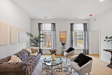 Detroit apartment for rent - a living room with a couch and two chairs and two windows