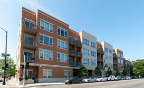 Chicago apartment for rent - a building on a city street with cars parked in front of it