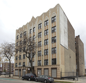 Chicago apartment for rent - a large brick building with cars parked in front of it