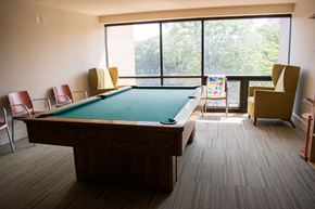 Chicago apartment for rent - a large room with a pool table and a balcony