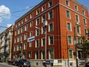 Cincinnati apartment for rent - a large red building on a city street