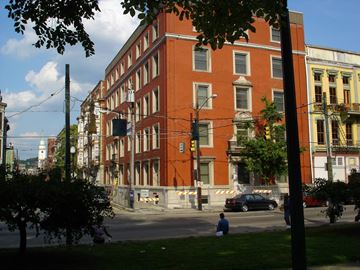 Cincinnati apartment for rent - a large red brick building on a city street