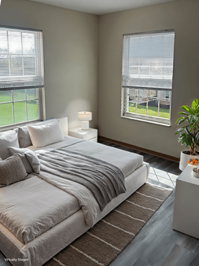 Blacklick apartment for rent - A bedroom with a large bed and a potted plant.
