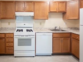 Hyannis apartment for rent - A kitchen with a white oven and a white dishwasher.